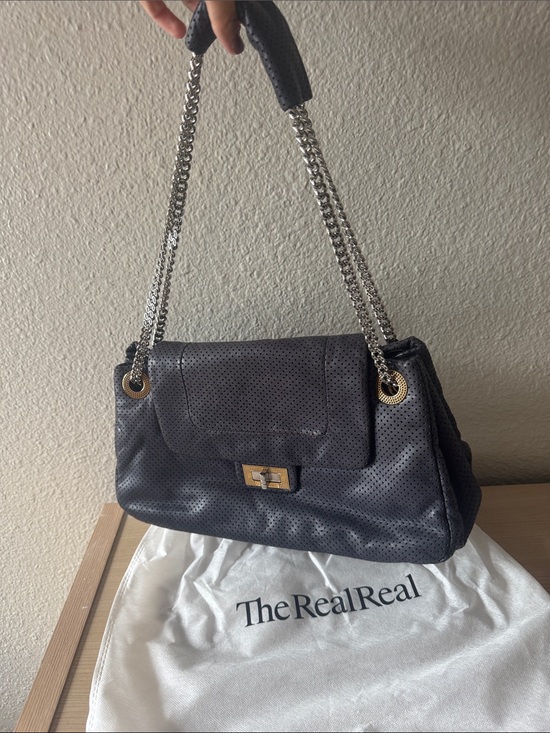 CHANEL Handbags - CHANEL Perforated Black Leather Shoulder Bag with Silver Chain
